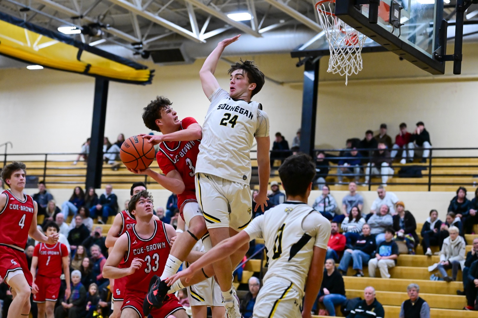 Athlete frozen in an awkward midair position during a high school game