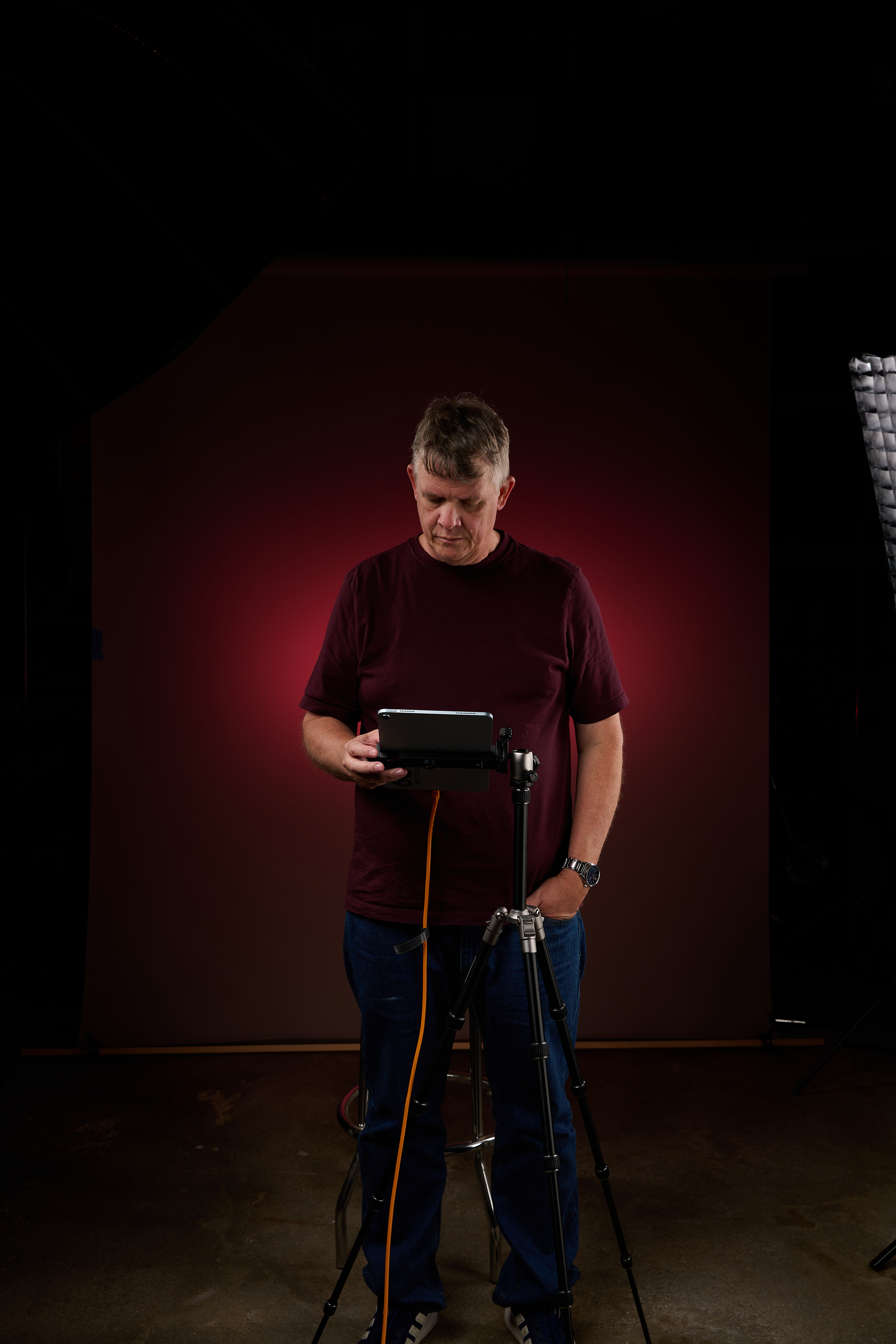 Rob Mulligan testing red accent lighting in the garage before Coe-Brown Media Day